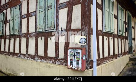 Traditional half-timbered house with green shutters and an old, nostalgic gumball machine, Upper Franconia Stock Photo
