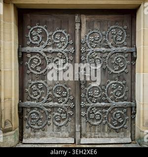 Massive wooden door decorated with filigree metal ornaments in medieval style, Erfurt Stock Photo