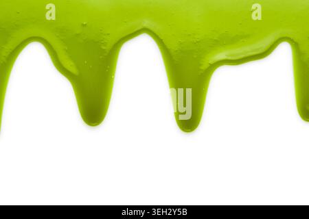 Green liquid transparent gel dripping down against white background. Stock Photo