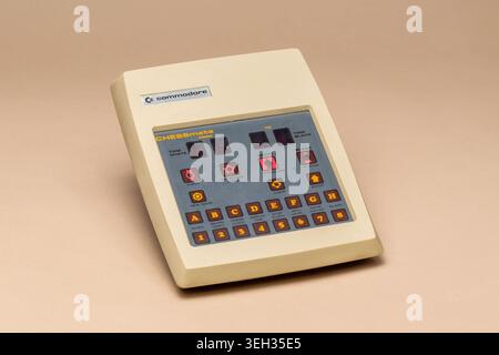 Pavia, Lombardy, Italy-March 30, 2026: Commodore Chessmate electronic chess computer from 1979. Beige design with chess piece buttons, on a beige back Stock Photo