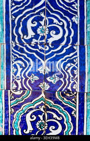 Ornate blue and white ceramic tilework with floral arabesque patterns from Islam Khoja Madrasah in Khiva. Detailed close-up of traditional Uzbek glaze Stock Photo