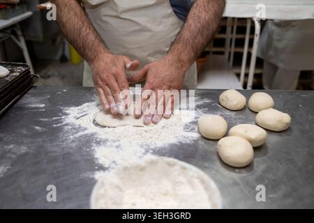 Baker hands kneading dough for artisan bread making Stock Photo