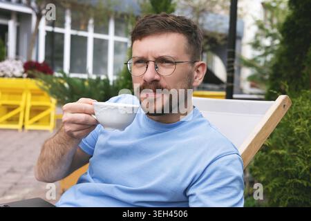 Happy man enjoying morning coffee on the terrace Stock Photo