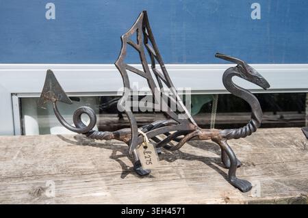 Hand-forged wrought iron dragon sculpture likely use perhaps as decorative boot jack or hearth accessory.Made by Brian Greaves on his floating forge. Stock Photo