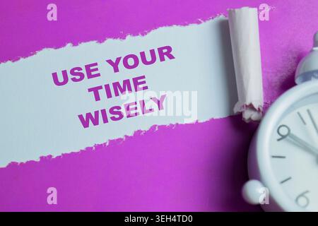 Use your time wisely text written in torn paper. Stock Photo