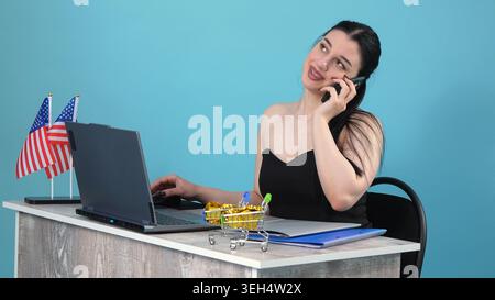 Young woman having a phone conversation in an office Stock Photo