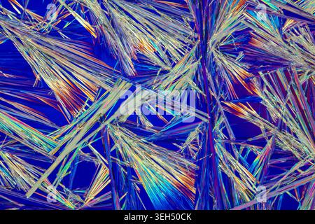 Epsom salt crystals under polarised light form a vibrant abstract landscape of colour and texture, revealing the hidden beauty of chemistry. Stock Photo