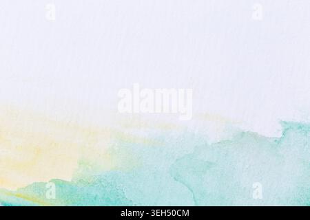 Macro close-up of hand painted faded light green and yellow watercolors on white background. High resolution textured paper background. Copy space. Stock Photo