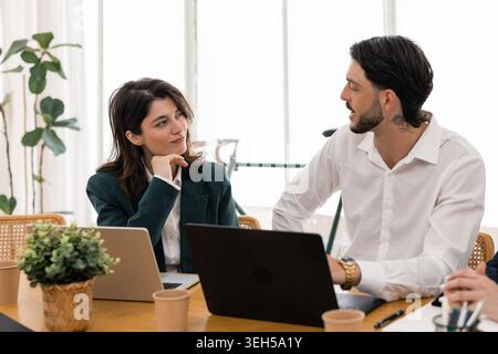 Business professionals collaborating in a modern office meeting Stock Photo