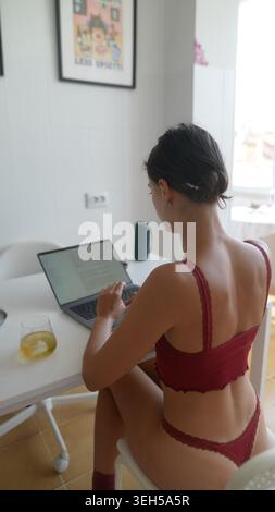 Lady develops visual aids while analyzing graphs on her computer Stock Photo
