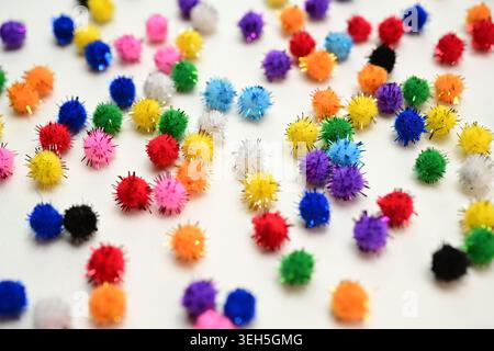 Colorful interlocking hook construction balls scattered on a white surface, creative children's educational building toy pieces in a bright layout. Stock Photo