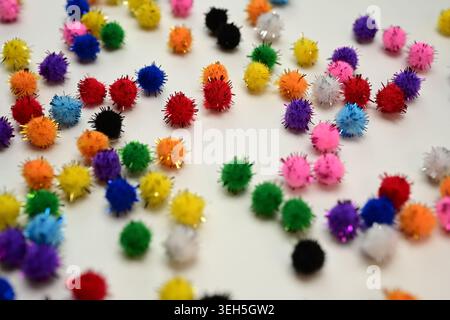 Colorful interlocking hook construction balls scattered on a white surface, creative children's educational building toy pieces in a bright layout. Stock Photo