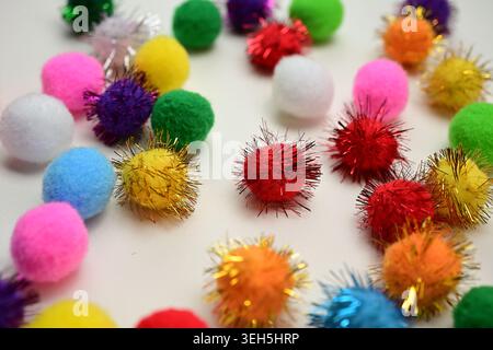 Colorful interlocking hook construction balls scattered on a white surface, creative children's educational building toy pieces in a bright layout. Stock Photo