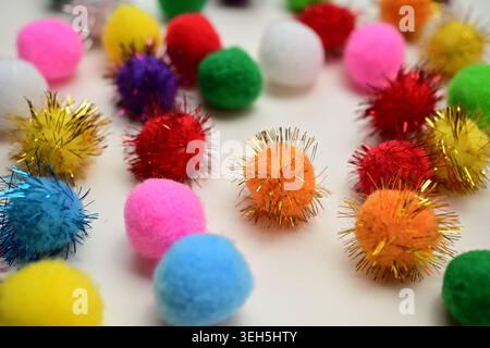 Colorful interlocking hook construction balls scattered on a white surface, creative children's educational building toy pieces in a bright layout. Stock Photo