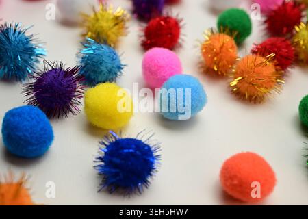 Colorful interlocking hook construction balls scattered on a white surface, creative children's educational building toy pieces in a bright layout. Stock Photo