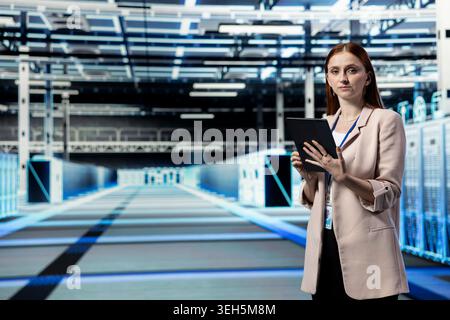 Upgrading systems, tablet and system administrator portrait in data center installing server racks. Monitoring infrastructure performance, device automation application and manager in server room Stock Photo