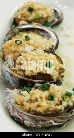 Steamed Abalone Served with Noodles and Garlic Stock Photo
