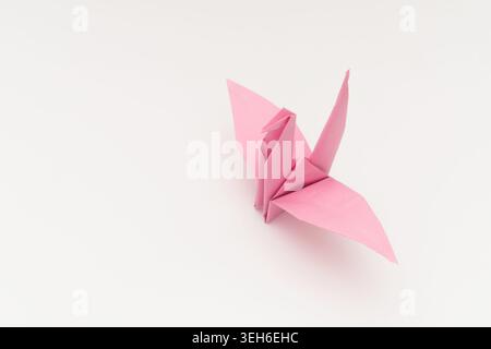 Pink Origami Paper Crane Isolated on White Background Stock Photo