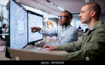 Two Financial Analysts Working Together Using Cloud Software To Process Invoices. Stock Photo