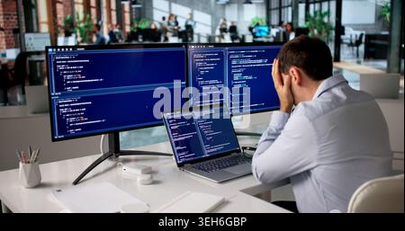 Frustrated Programmer Struggles Alone Late Night Coding Web Software. Stock Photo