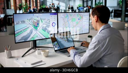Engineer Studies Urban Property Maps On Laptop Using BIM And GIS Software. Stock Photo