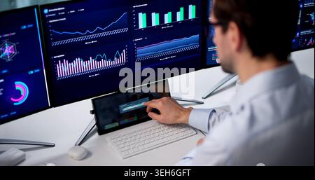 Mature Man Uses Computer To Analyze Financial Data And Make Decisions. Stock Photo
