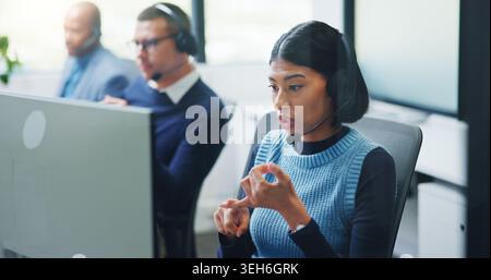 Discussion, woman and headset at computer in call center for cold calling, explain offer and agent. Telemarketing, sales consultant or talk on tech Stock Photo