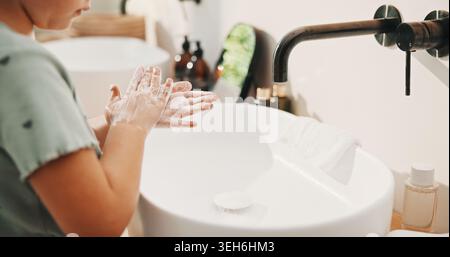 Health, washing hands or kid in home for wellness, bacteria removal or hygiene in child growth. Safety, clean or girl in house with routine, virus Stock Photo