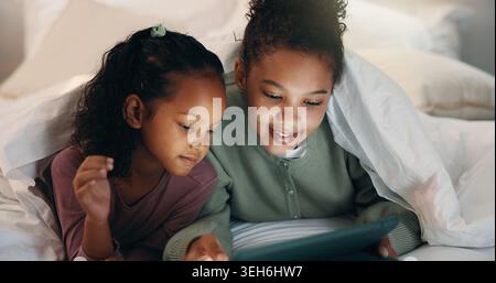 Relax, children or siblings with tablet in bed, watch cartoon or streaming video for weekend bonding. Family subscription, movie website and girls Stock Photo