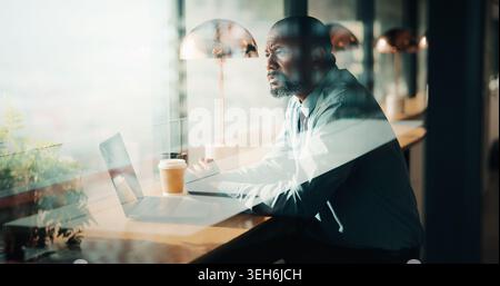 Serious, business and thinking with black man at cafe for accounting, planning and audit solution. Mature person, laptop or accountant with reflection Stock Photo