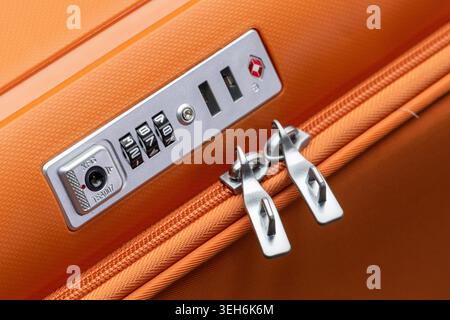 Close Up of Suitcase Combination Lock and Zipper on Orange Travel Luggage Stock Photo