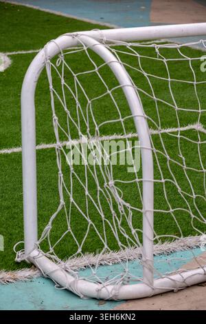 Empty Football Field With Goal Post and White Marking Lines on Green Artificial Turf Stock Photo