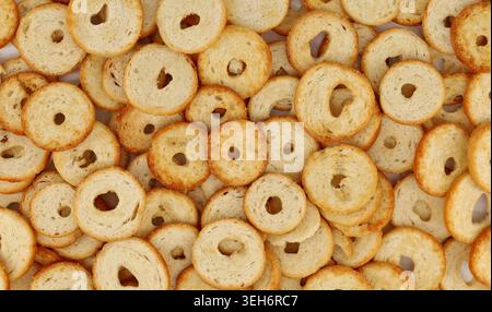 Ring shaped chips of bread with a hole in the middle. Full frame, background and texture Stock Photo
