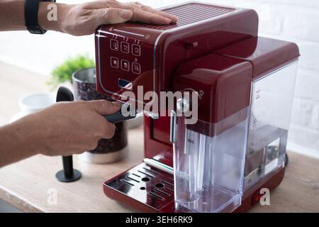 Preparing espresso coffee in a modern kitchen.Close up. Stock Photo