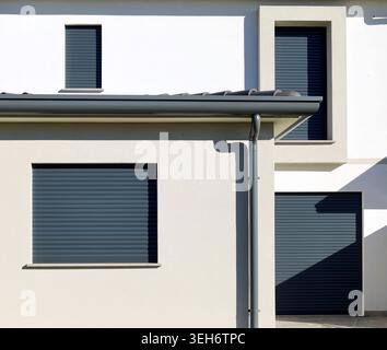 Dark gray modern rolling shutters on a facade of a new built house. Stock Photo
