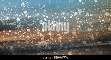 Abstract digital art background featuring a dynamic blend of soft motion-blurred streaks and floating glowing bokeh particles in blue and warm earth t Stock Photo