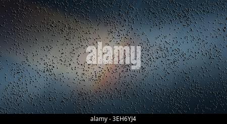 A sophisticated abstract background featuring a dark, moody atmosphere with a dense layer of small particles and a soft, glowing light effect in the c Stock Photo