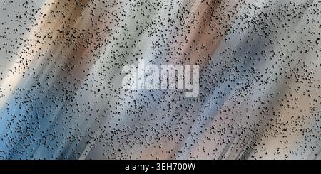 Abstract digital design featuring a field of small dark particles scattered over a background with diagonal motion blur in shades of blue and brown. Stock Photo