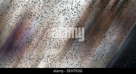 A dynamic abstract composition with a motion-blurred gradient background in shades of grey and brown, covered by a layer of small dark particles. Stock Photo
