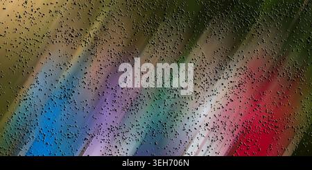 A colorful abstract image featuring a multi-colored motion blur background with streaks of red, blue, and green, layered with dark textured particles. Stock Photo