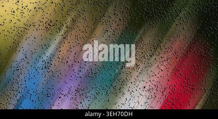A vibrant abstract composition with diagonal motion blur in a spectrum of colors including blue, green, red, and yellow, covered in dark textured dots Stock Photo