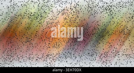 An abstract digital art composition featuring diagonal motion blur streaks in warm and cool tones, overlaid with a scattered pattern of small black do Stock Photo