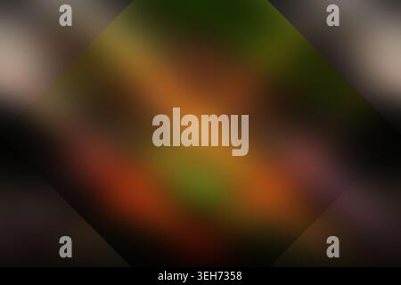 A moody, abstract background blending deep dark tones with warm orange, red, and green hues, perfect for artistic and atmospheric compositions. Stock Photo
