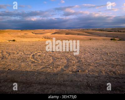 The Barren Stony Landscape of Agafay Desert with the Majestic Atlas Mountains in the Background, Morocco, North Africa Stock Photo
