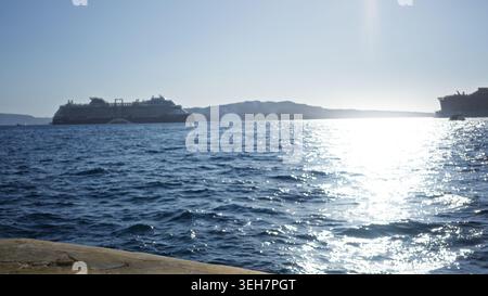 Distant cruise ships and sparkling ocean waters in a soft defocused seascape outdoor; background backplate backdrop copyspace. Stock Photo