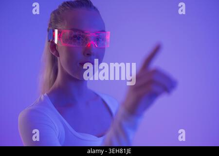 Woman Interacting with Virtual Interface Stock Photo