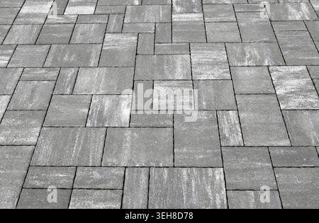 Gray  and white concrete outdoor pavement with tiles of different shapes. Background and texture. Stock Photo
