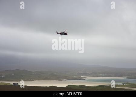 Coast Guard Helicopter over Uig bay Isle of Lewis Scotland. Stock Photo
