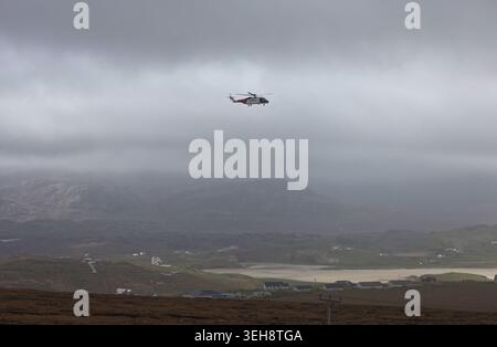Air sea rescue helicopter over Uig Isle of Lewis Scotland. Stock Photo