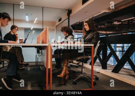 Young professionals working in a modern business office shared workspace during the day Stock Photo